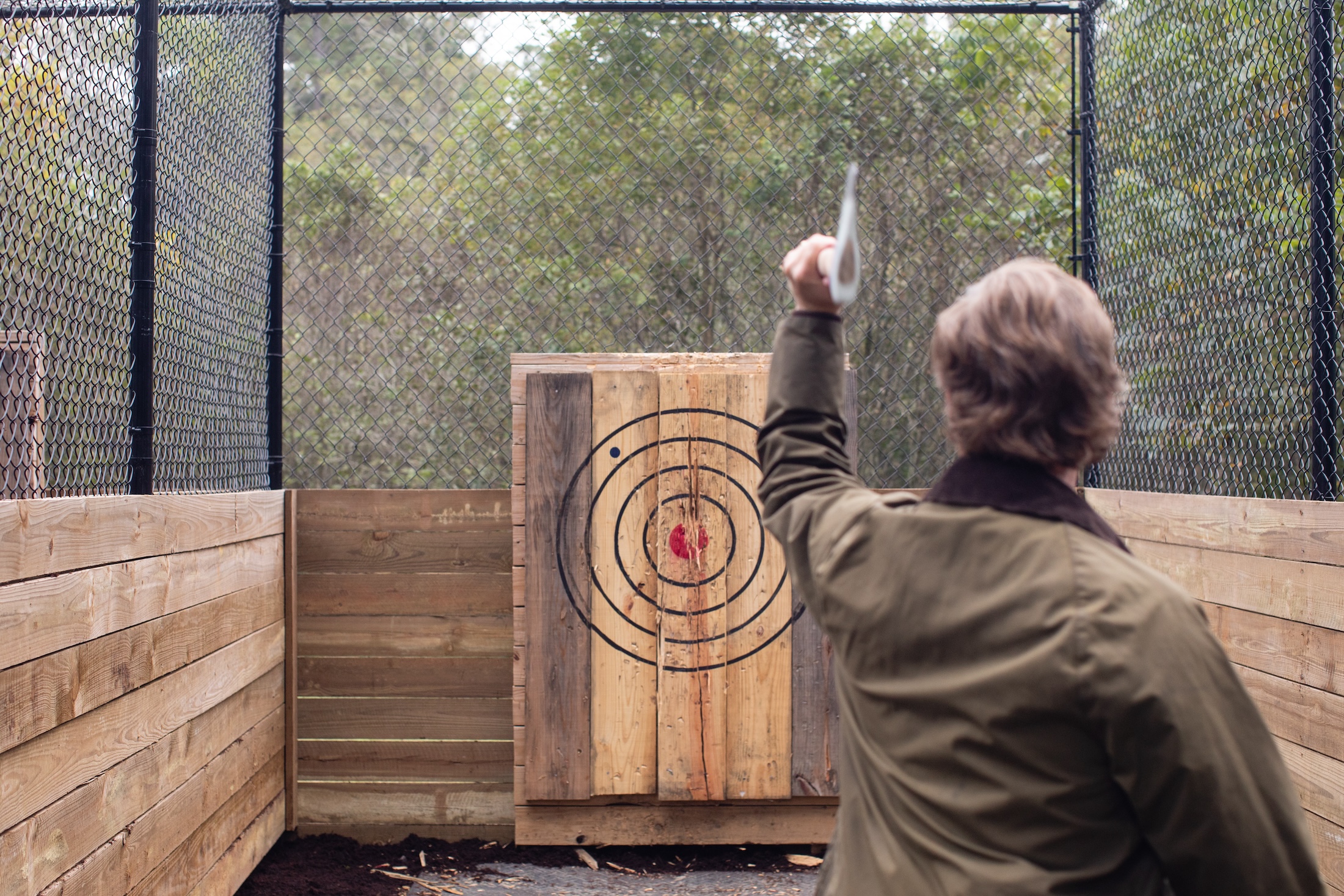 A man aims to throw an axe at a target at Barnsley Resort.