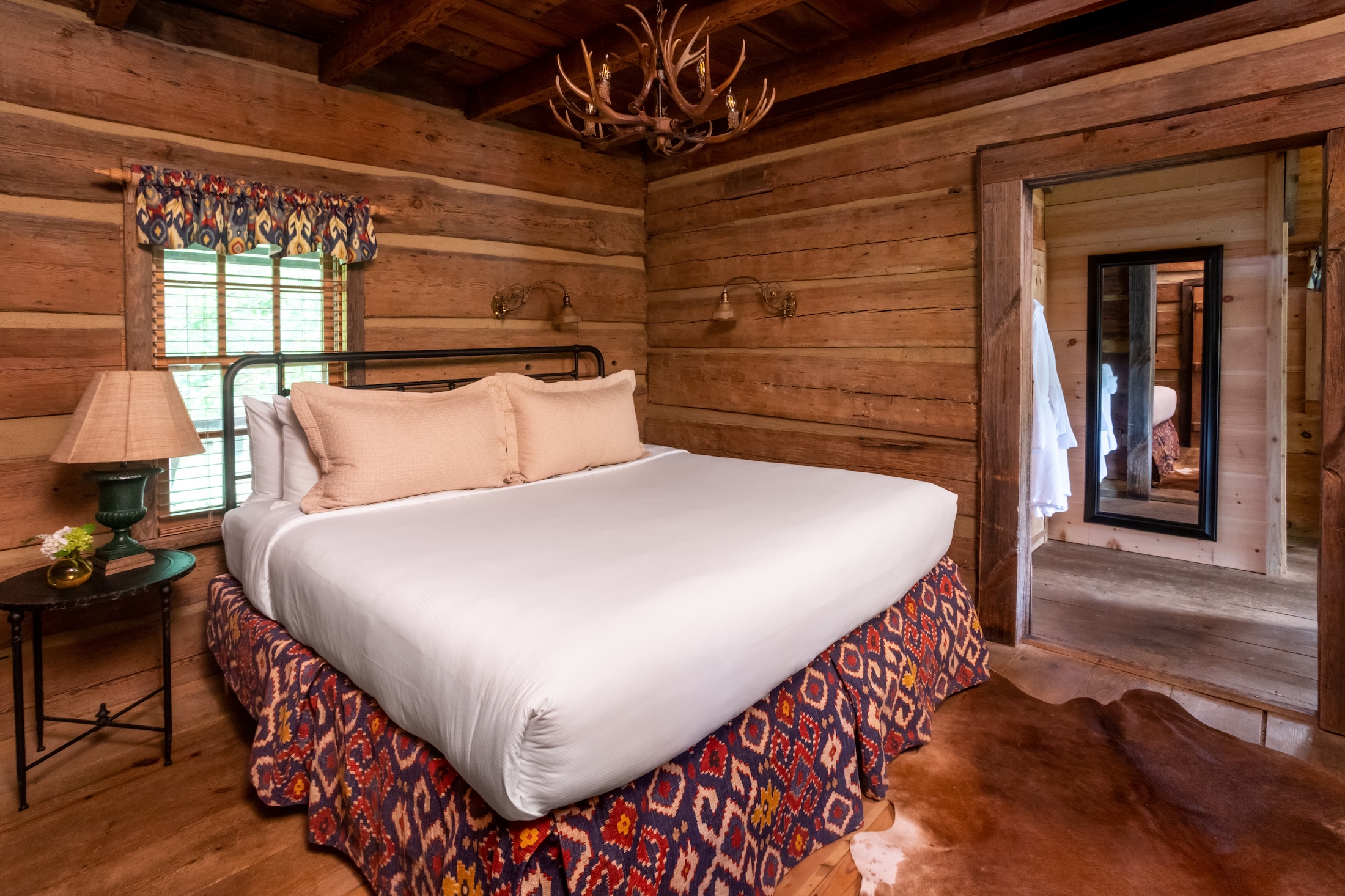 A cozy king bedroom in the Fugger Cabin at Barnsley Resort.