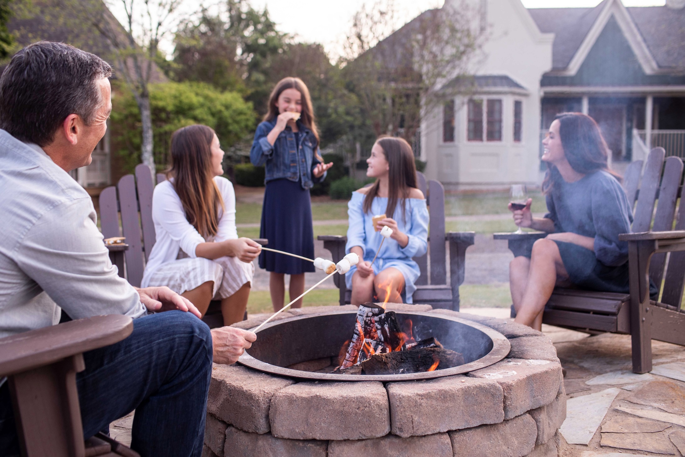 A family roasts marshmallows on a fire outside of Barnsley Resort.