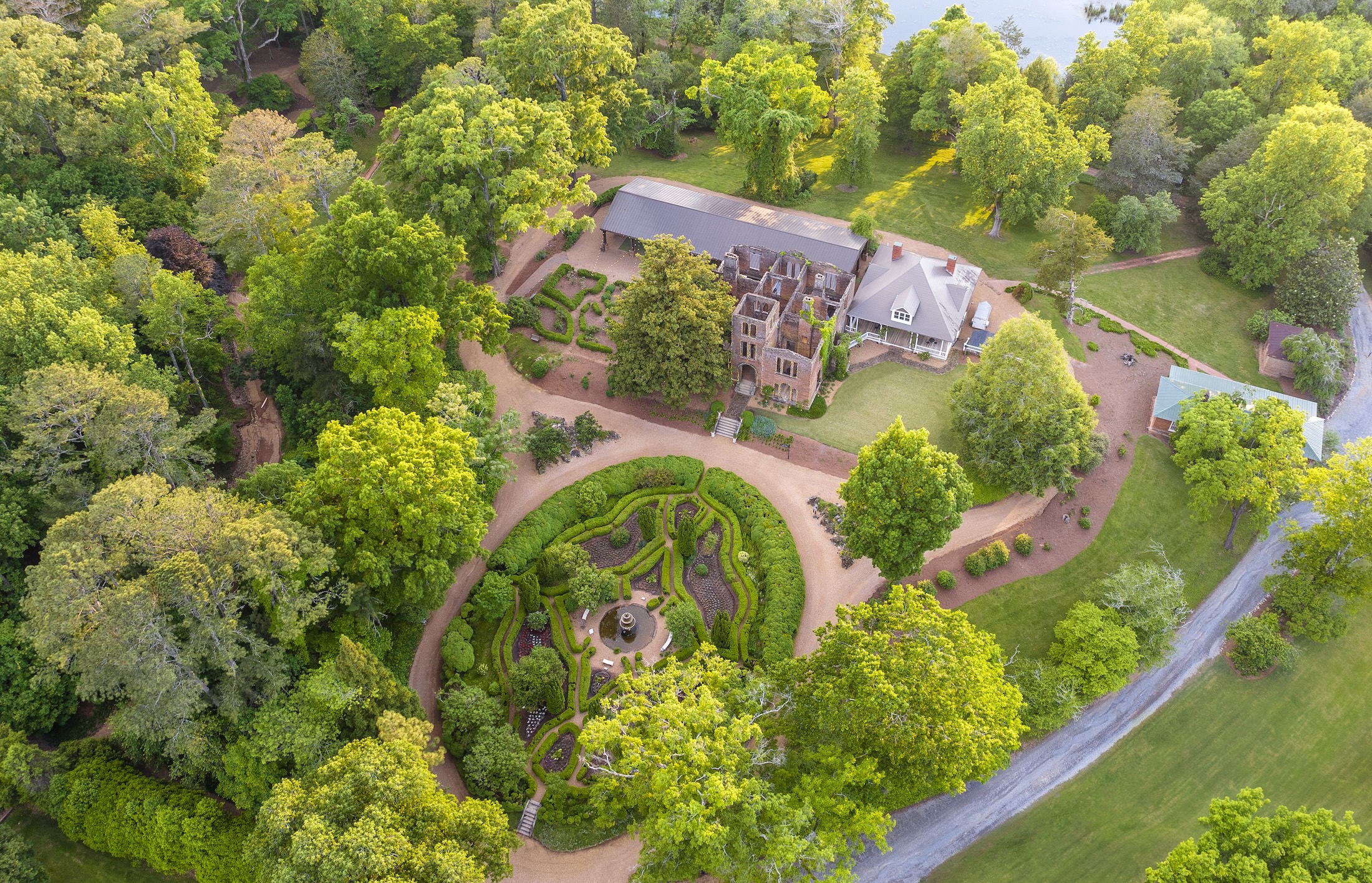 An aerial view of Manor House Ruins and gardens at sunrise.