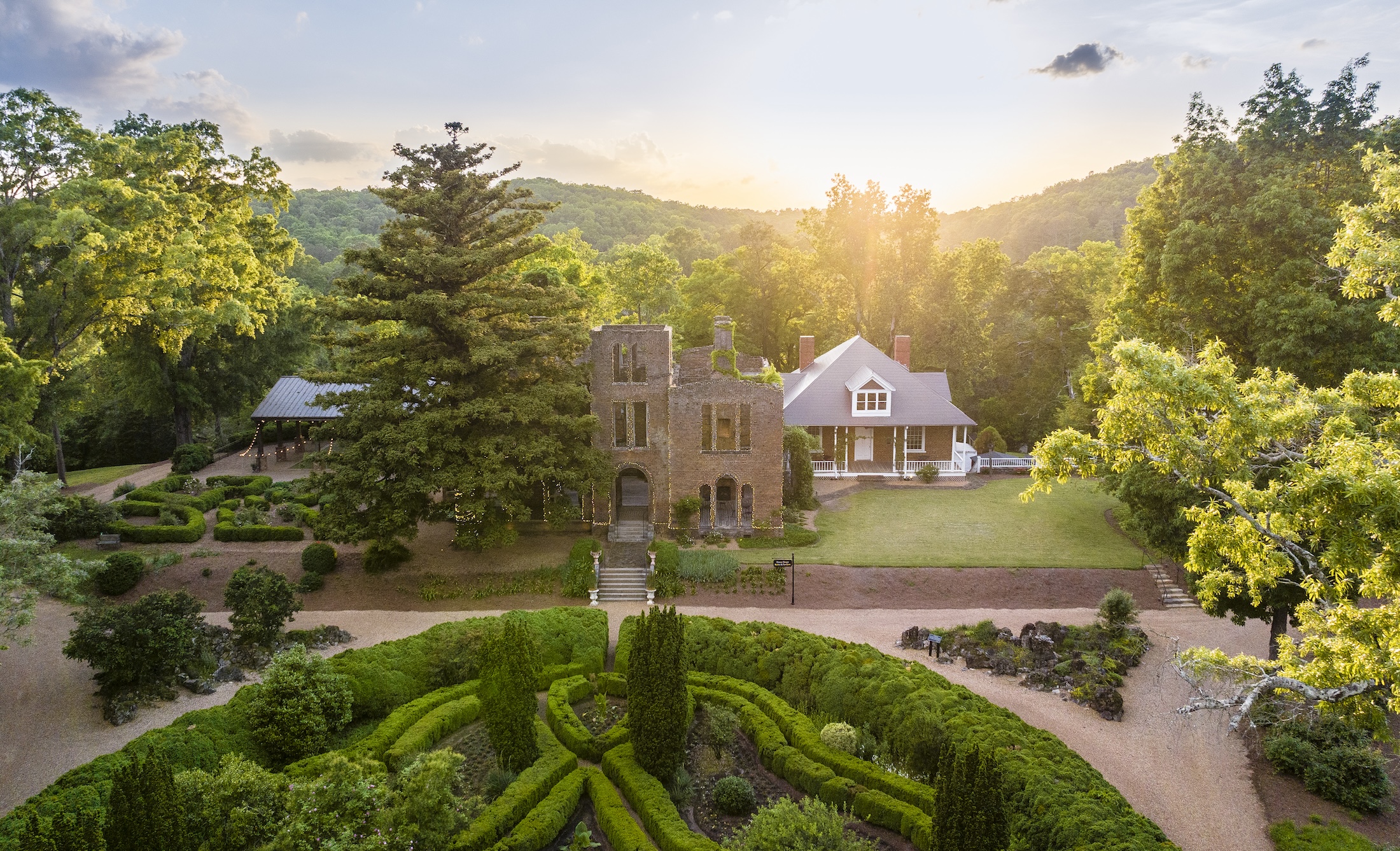 An aerial view of Manor House Ruins and gardens at sunrise.