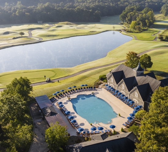 An aerial view of the resort pool looking out on the golf course at Barnsley Resort