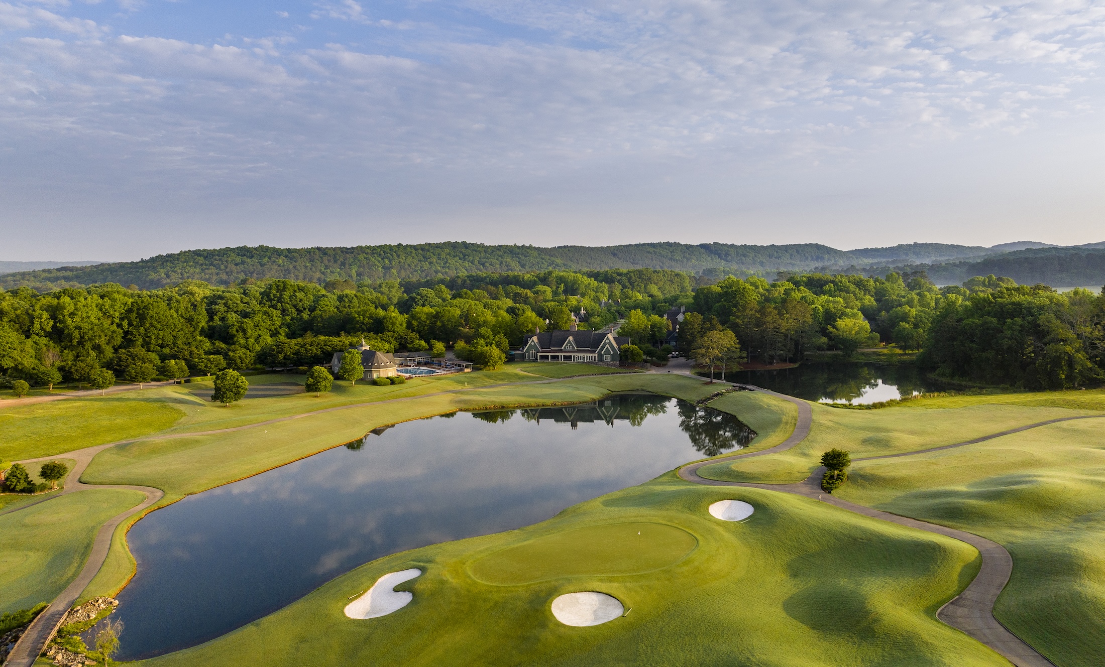 An aerial view of the golf course and village on a calm sunny day at Barnsley Resort.