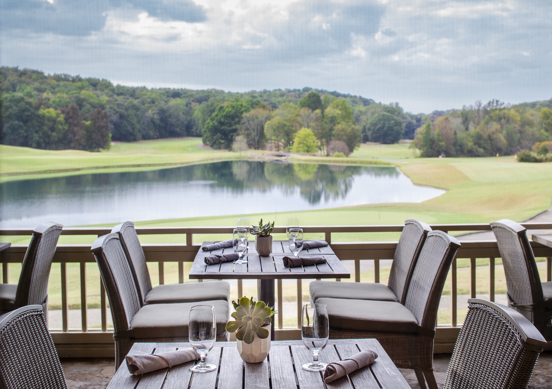 The outdoor seating area overlooking the golf course at Woodlands Grill.