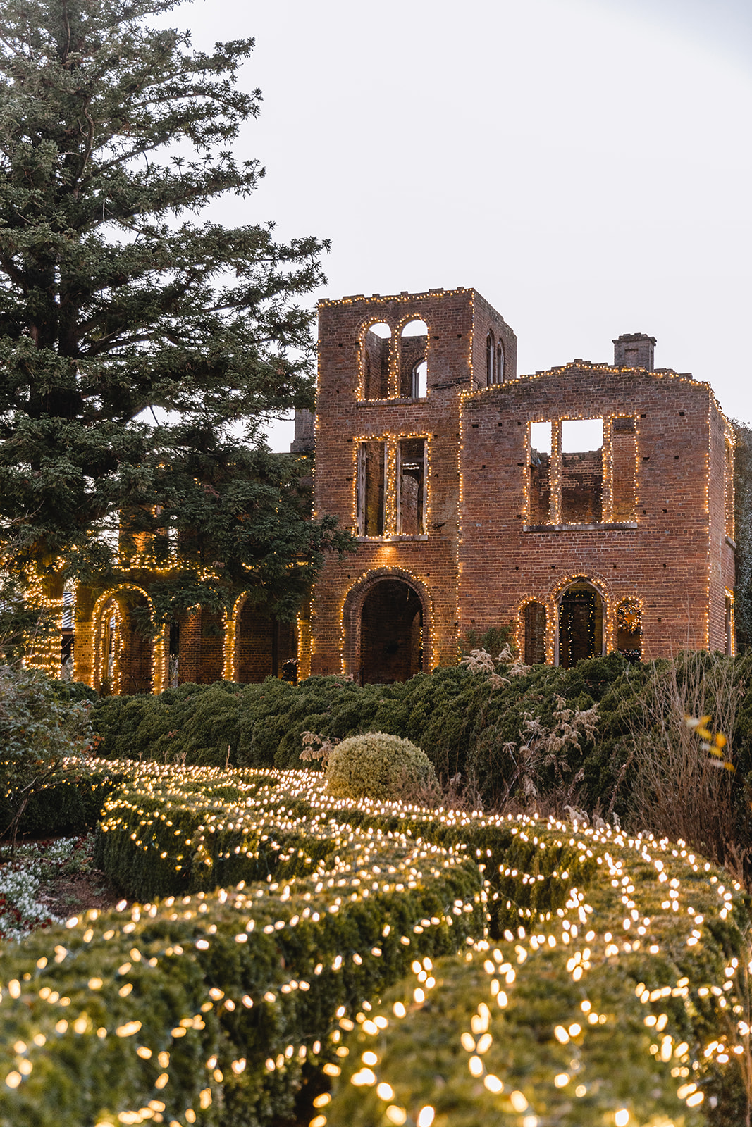 Manor House Ruins decorated with white holiday lights.