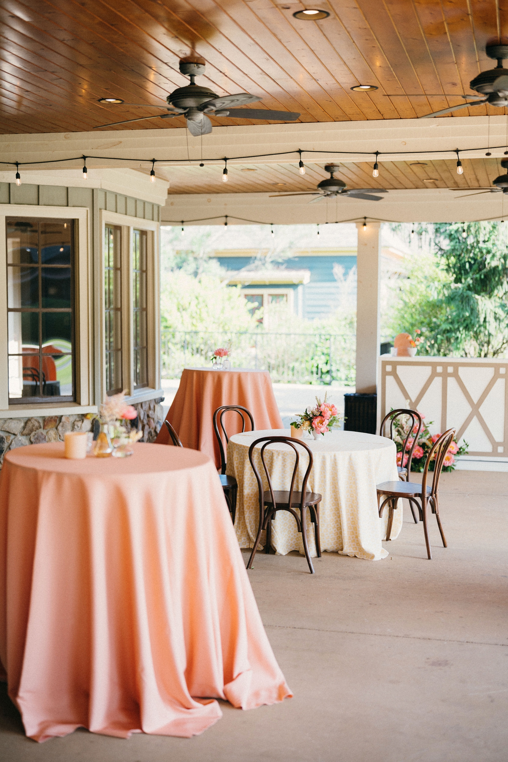 A few tables set with pink and white table cloths on the Saylor Hall Terrace.